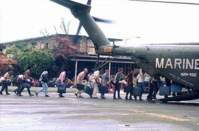 Vietnamese people evacuating Vietnam via a US Marine Corp helicopter in 1975