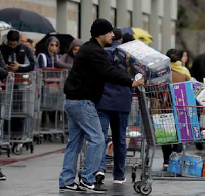 Man pushing an overloaded shopping cart during the COVID-19 pandemic